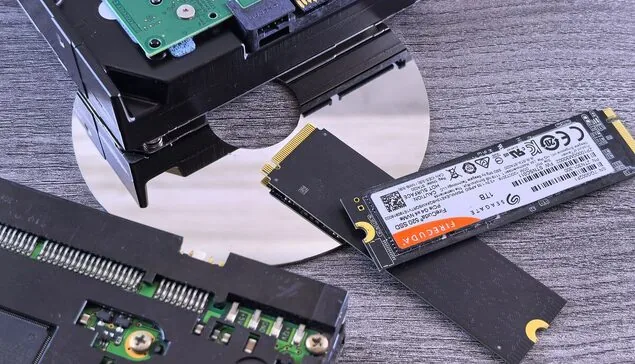Dysk twardy HDD obok dysku SSD M.2 na blacie — błędy SMART dysku — kiedy wymienić nośnik